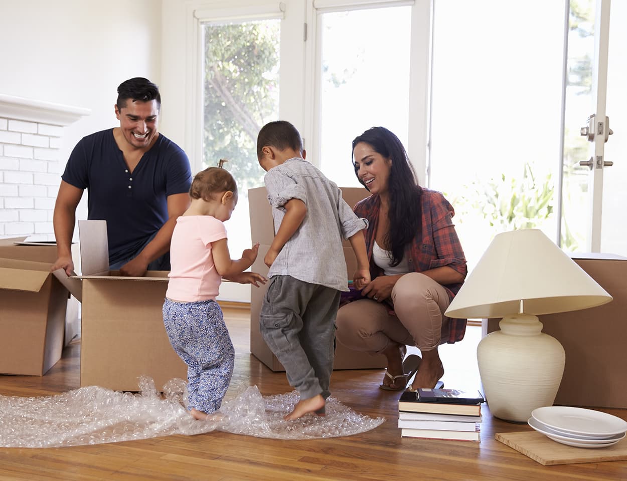 Happy family unpacking in new home